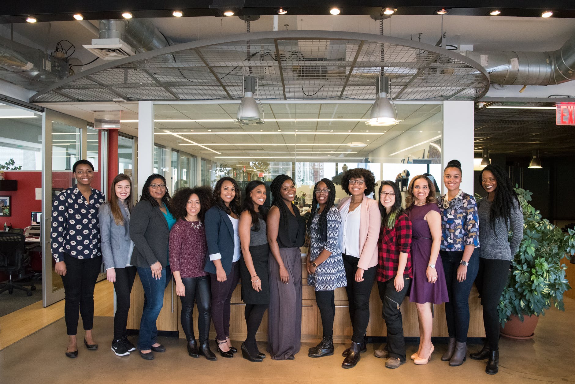 group of women standing near desk